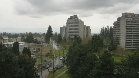 Rainy cloudy city view of road with car and high-rises Stock Footage 63750962