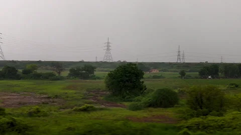 Rainy countryside view from moving train window Stockbeeldmateriaal 317806023