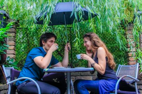 Rainy date for a young couple Stock Photos
