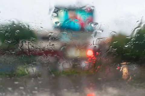 Rainy day background with copy space. Drops of water on car glass.Entering th Stock Photos