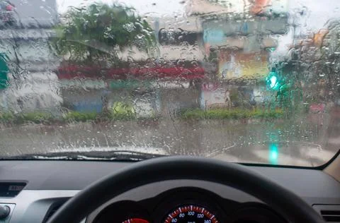 Rainy day background with copy space. Drops of water on car glass.Entering th Stock Photos