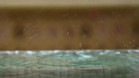 Rainy day in the city. Rain drops on plastic table surface. Video stock 255482964