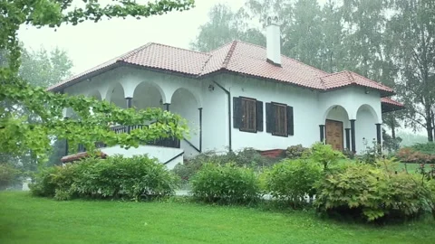 Rainy day in countryside with big rustic house in beautiful green environment Stock Footage 205077077