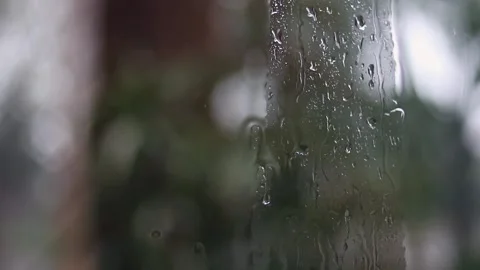 Rainy day, drops on window glass seen from inside the house looking out Stock-Footage 331107336