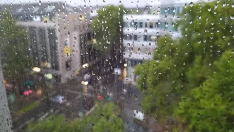 Rainy day in office with falling and dripping raindrops on a window Stock Footage 140952754