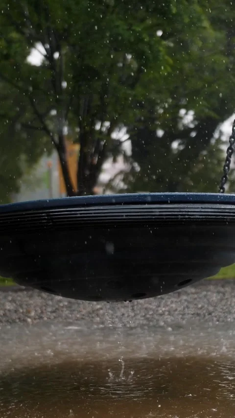 Rainy Day at the Park: Empty Swing and Wet Playground Equipment Stock Footage 313343741