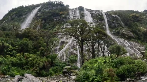Rainy Day at Sandfly Point: Dramatic Waterfalls Cascading from Lush Cliffs .. Stock Footage 295247577
