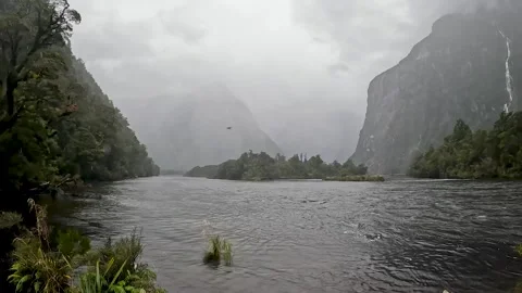 Rainy Day at Sandfly Point: Dramatic Waterfalls Cascading from Lush Cliffs .. Stock Footage 295247734