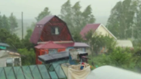 Rainy day scene, focus rain falling in sky with blur house background Stock Footage 82198148