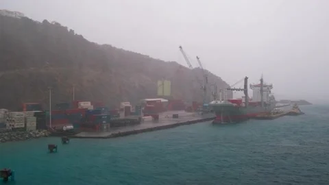 Rainy day in Sint Maarten cargo port, tropical downpour hit freight terminal Video stock 233398345
