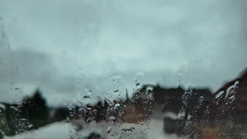 Rainy Day Street View Through a Wet Window in the Early Morning Hours Stock Footage 288005244