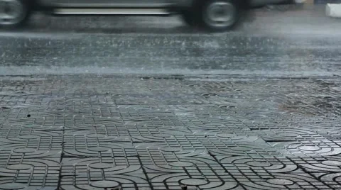 Rainy Day in Vietnam - Low Angle Shot Rain on Pavement Sidewalk of Street Stock Footage 63296207