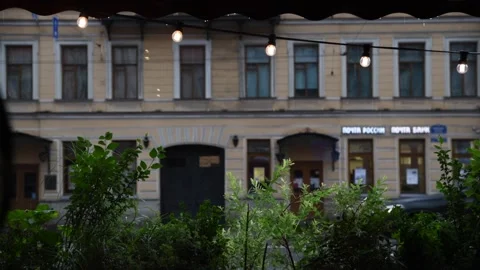 Rainy day view from a cozy Saint Petersburg cafe with greenery Stock Footage 302113200