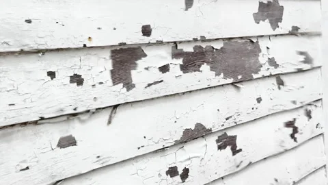 Rainy day view of old paint flaking off weathered wooden siding ensuring mo.. Stock Footage 339356729