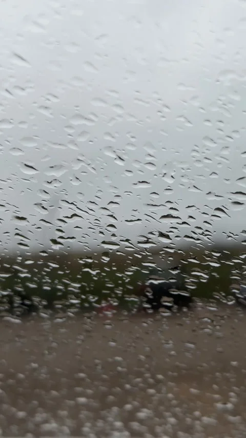 Rainy Day View Through a Car Window. Water Droplets on Glass Stock Footage 320570374