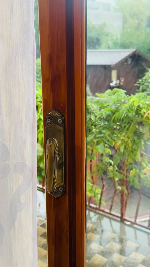Rainy day view through wooden window with brass handle. Stock Footage 319793032