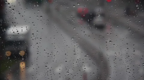 Rainy days, Rain drops on window with blurred traffic Stock Footage 53839686