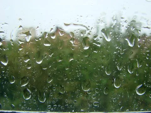 Rainy days rain drops on the window surface Stock Photos