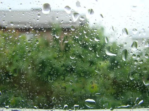 Rainy days rain drops on the window surface Stock Photos