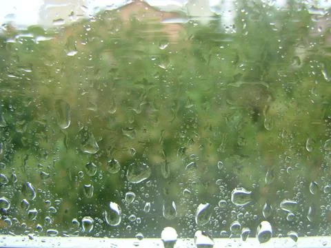 Rainy days rain drops on the window surface Stock Photos