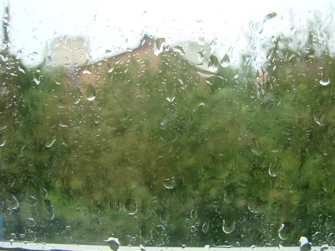 Rainy days rain drops on the window surface Stock Photos