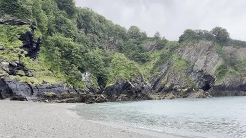 Rainy deserted beach and cliff still shot in Devon England Stock Footage 246475694