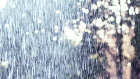 Rainy drops in slow motion. Raindrops on the background of the sun. Stock Footage 160295322