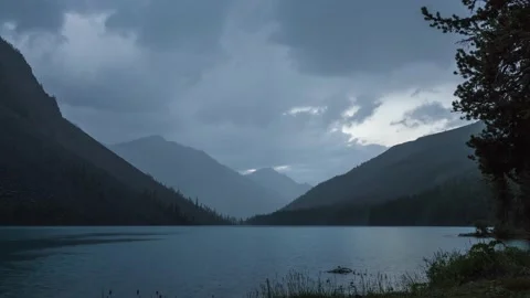 Rainy evening over a mountain lake. large dark clouds are floating across Stock-Footage 157304596