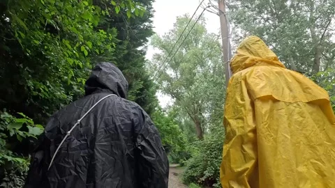 Rainy Forest: Two People Exploring in Rain Coats Stock Footage 278143740