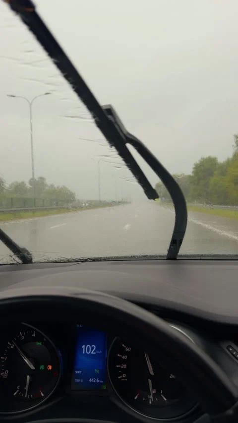 Rainy highway view from car interior with blurred windshield, dashboard Stock Footage 345530377