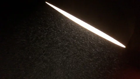 Rainy mist moving in spotlight above garage Stock Footage 100610096