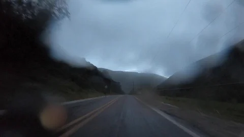 Rainy mountain driving time-lapse in a cloudy sunset 4K Stock Footage 127763309