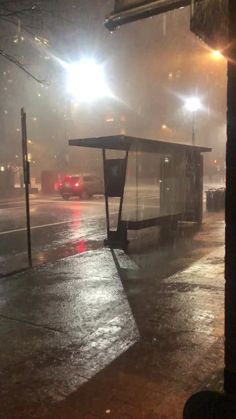 Rainy night at bus stop Stock Footage 260893049