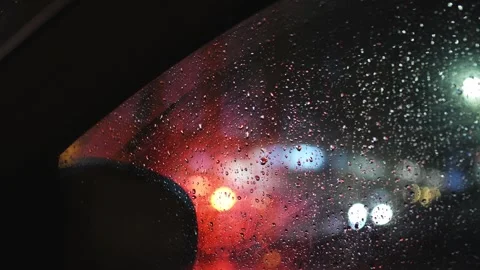 Rainy night car window with city bokeh lights through wet glass, 4K Stock Footage 340478677