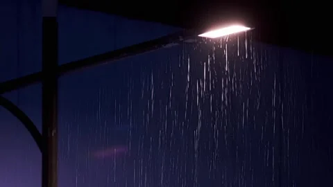 Rainy night - heavy rain under the street lights Stock Footage 258187796