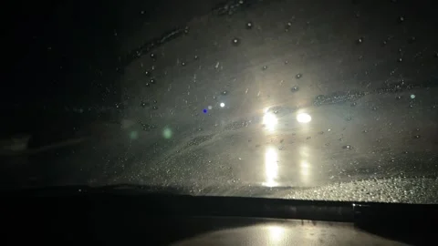 Rainy Night Road Through Windshield. Driving in rainy season at midnight. D.. Stock Footage 326239743