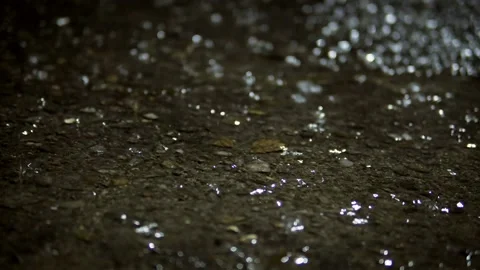 Rainy night scene with water puddles on dark asphalt road Stock Footage 337446579