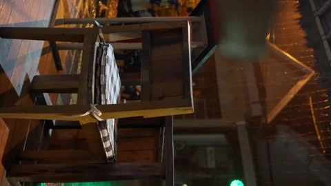 Rainy night, view from a cafe to a night street. Chair close-up, Vertical video 스톡 동영상 255784837