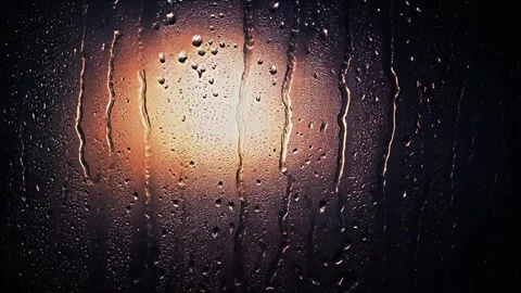 Rainy night view through wet window with warm light 스톡 동영상 338189522