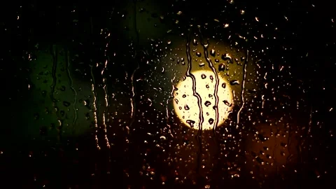 Rainy Night Window with Glowing Streetlight Bokeh Stock Footage 327204357