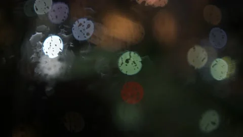 Rainy nighttime window and bokeh cirlces form abstract shot Stock Footage 157666118