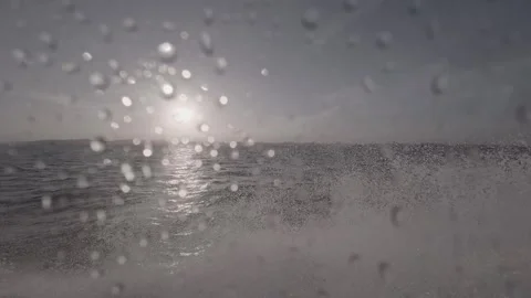 Rainy ocean view with sunlight reflecting off water surface during storm Stock Footage 331728158