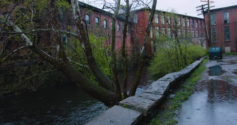 Rainy river between old mill buildings 動画素材 239340294