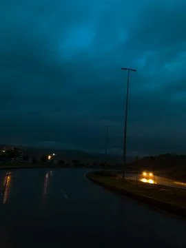 Rainy road at evening Stock Photos