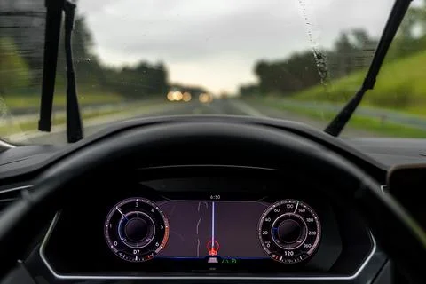 Rainy road through windshield. Driving weather and transport content. Stock Photos