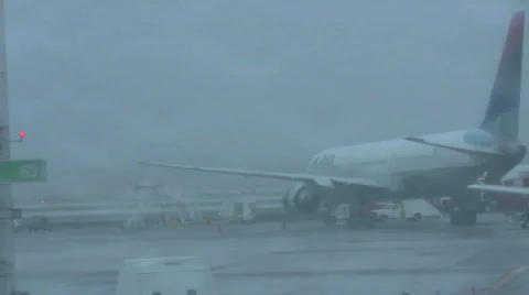 Rainy runway with plane on tarmac Stock Footage
