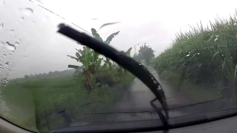 Rainy rural road view through car windshield Stock Footage 279717789