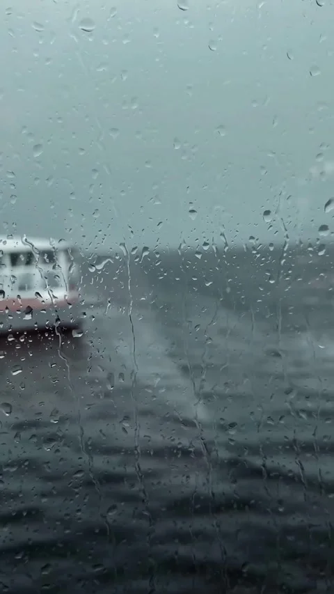 Rainy scene through window, with raindrops streaming down glass. Stock Footage 305313240