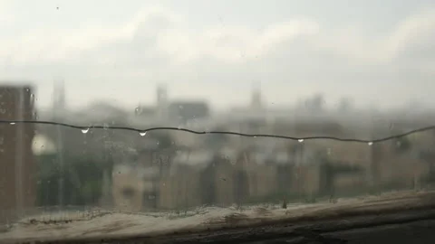 Rainy sky behind window glass. Gloomy Blurred view rain clouds landscape Stock Footage 311046243