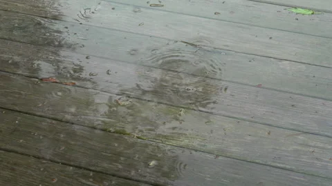 Rainy Spring Day with Puddles and Ponding on Wooden Deck Stock Footage 308836100